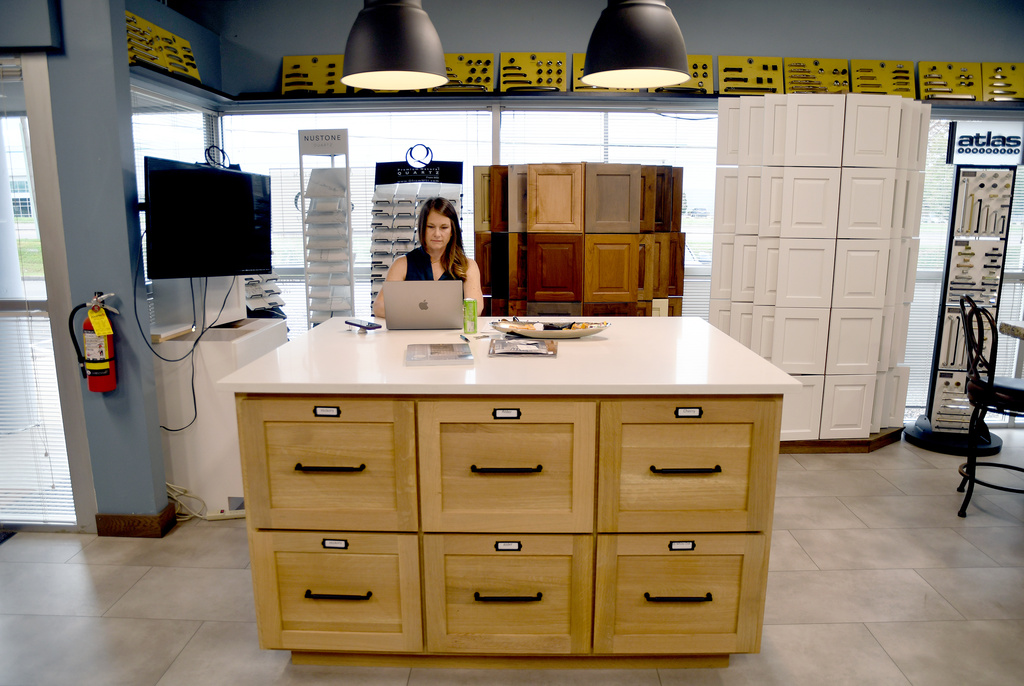 Andrea Mulkey, president and founder of Amish Cabinets of Denver, works in her showroom in Denver on Friday, Oct. 10, 2025. (AP Photo/Thomas Peipert)