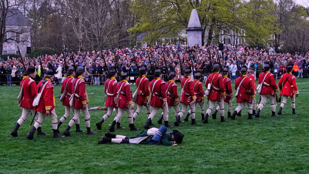 British red coat soldiers march past a fallen colonial minute man during the historic re-enactment of the Battle of Lexington, Saturday, April 18, 2026, in Lexington, Mass. (AP Photo/Charles Krupa)
