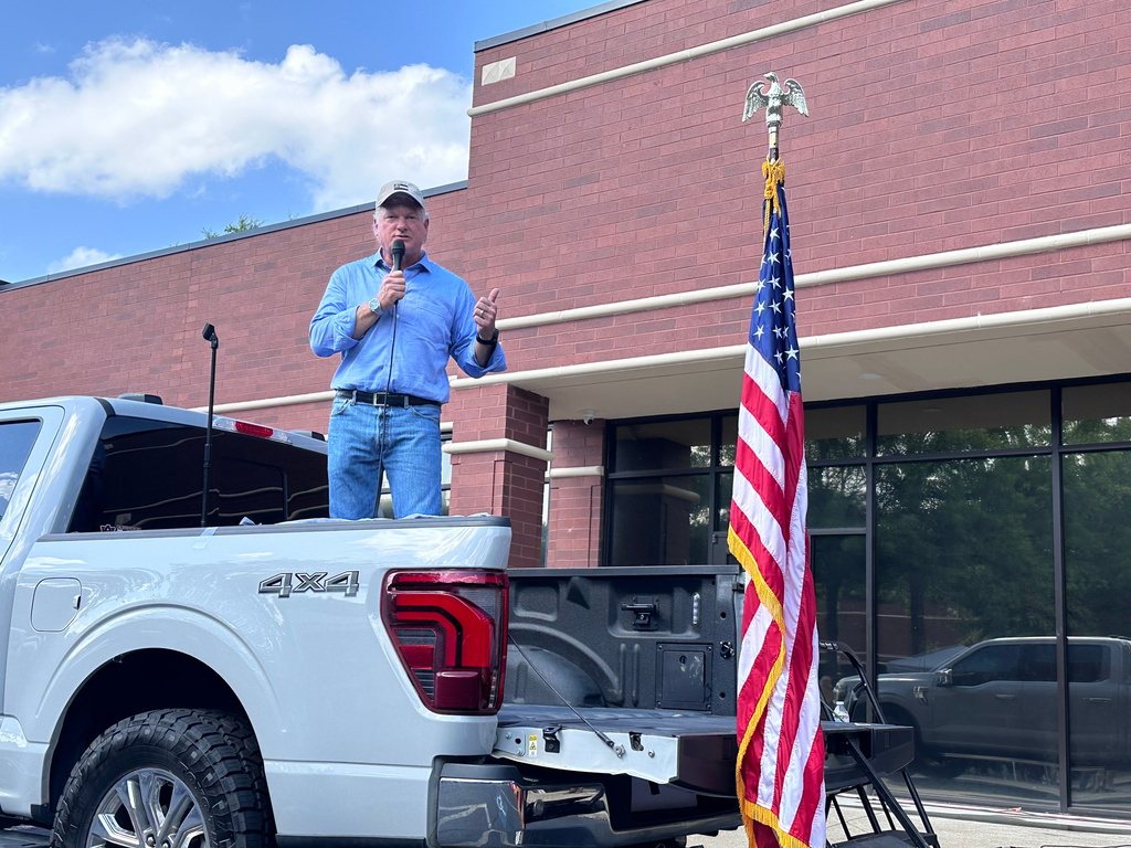 U.S. Rep Mike Collins campaigns in Woodstock, Ga., Sunday, June 14, 2026. ( AP Photo/Bill Barrow)