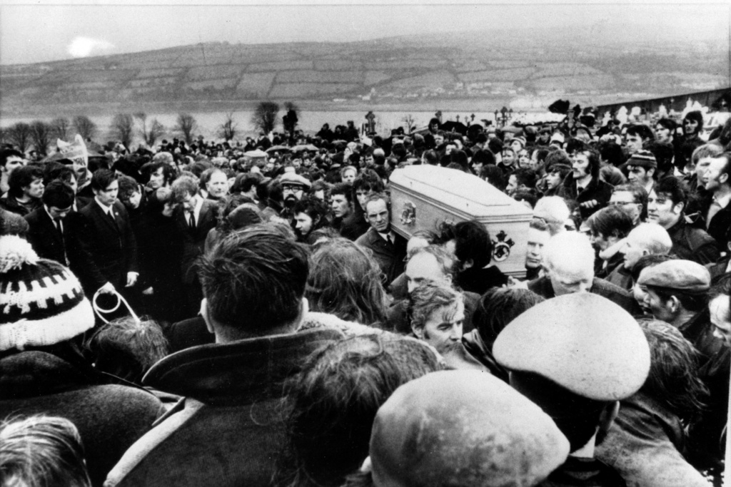 FILE - Pallbearers carry one of 13 coffins of Bloody Sunday victims to a graveside during a funeral in Londonderry, Northern Ireland, following requiem mass at nearby St. Mary's church at Creggan Hill, on Feb. 2, 1972. (AP Photo/File)