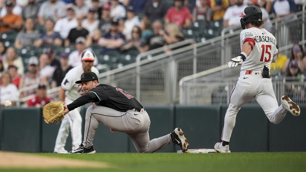 Arizona Diamondbacks second baseman Tim Tawa (13) fields a ball as Minnesota Twins' Luke Keaschall (15) is safe at first base inning of a baseball game, Saturday, Sept. 13, 2025, in Minneapolis. (AP Photo/Mike Stewart)