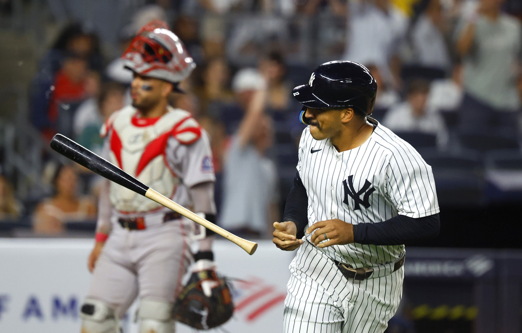 New York Yankees' Trent Grisham tosses his bat after hitting a home run during the fifth inning of a baseball game against the Boston Red Sox, Sunday, Aug. 24, 2025, in New York. (AP Photo/Noah K. Murray)