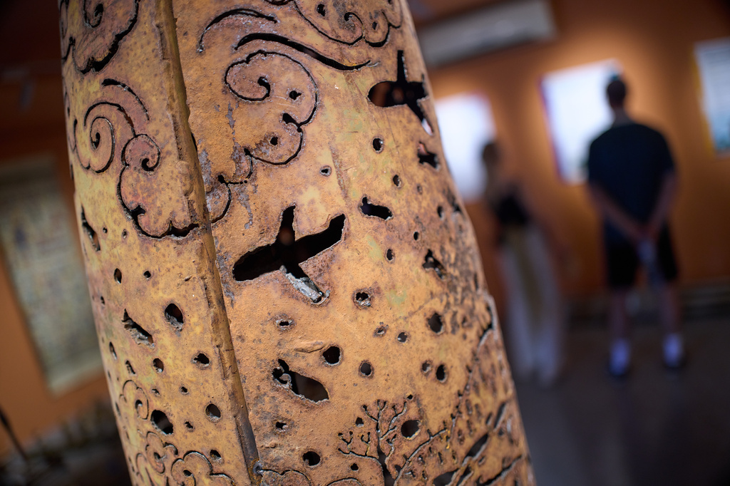 Metal artwork engraved with wartime scenes is seen created from remnants of unexploded ordnance found during clearance operations, displayed at the UXO Lao Visitor Center in Luang Prabang, Laos, Monday, Nov. 3, 2025. (AP Photo/Eugene Hoshiko)