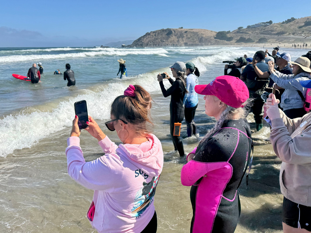 Spectators watch the surfing dogs during the World Dog Surfing Championships, Saturday, Aug. 1, 2026, in Pacifica, Calif. (AP Photo/Haven Daley)
