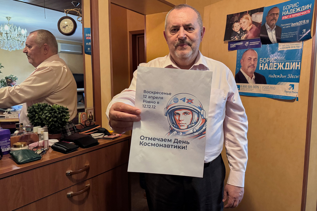 Opposition politician Boris Nadezhdin holds a poster while speaking to journalists, in Moscow, Wednesday, April 1, 2026. (AP Photo)