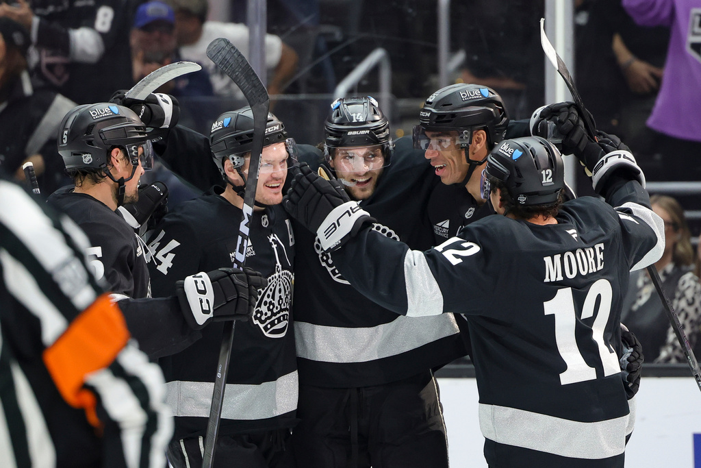 Los Angeles Kings right wing Alex Laferriere, center, celebrates with defenseman Cody Ceci, defenseman Mikey Anderson, right wing Quinton Byfield, and left wing Trevor Moore, from left, after scoring during the second period of an NHL hockey game against the Calgary Flames Saturday, Feb. 28, 2026 in Los Angeles. (AP Photo/Ryan Sun)