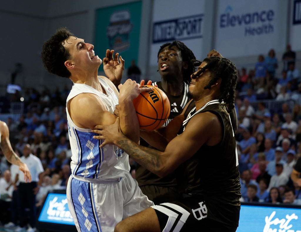 North Carolina guard Luka Bogavac fights for a rebound with St. Bonaventure guard Amar'E Marshall during the first half of an NCAA college basketball game, Tuesday, Nov. 25, 2025 in Ft. Myers, Fla. (AP Photo/Scott Audette)