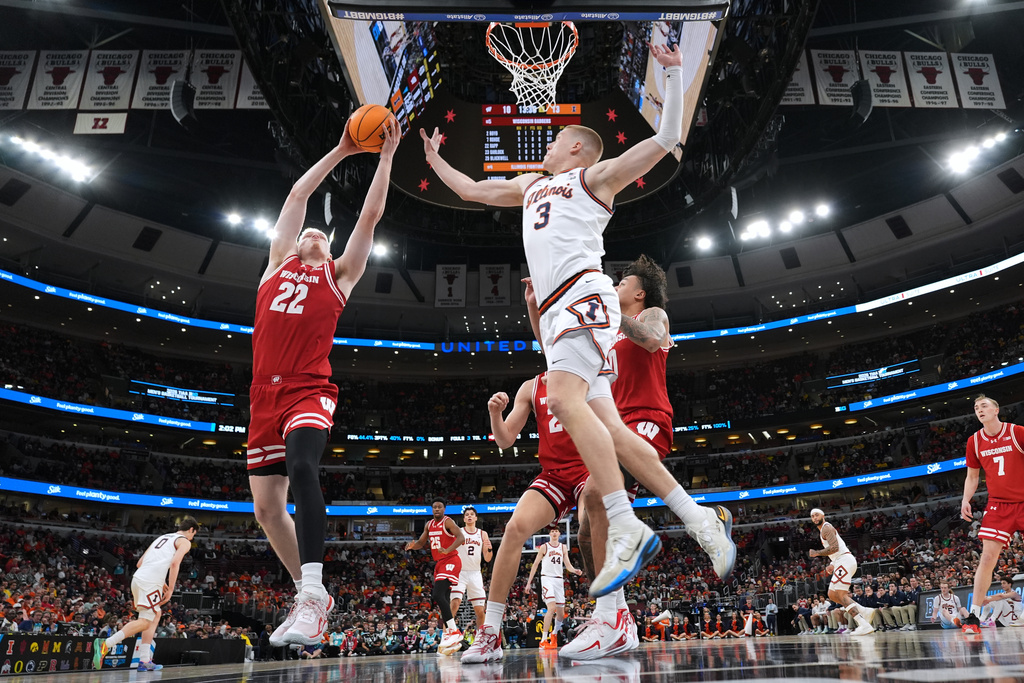 Wisconsin forward Austin Rapp, left, rebounds a ball against Illinois forward Ben Humrichous during the first half of an NCAA college basketball game in the quarterfinals of the Big 10 Conference tournament, Friday, March 13, 2026, in Chicago. (AP Photo/Nam Y. Huh)