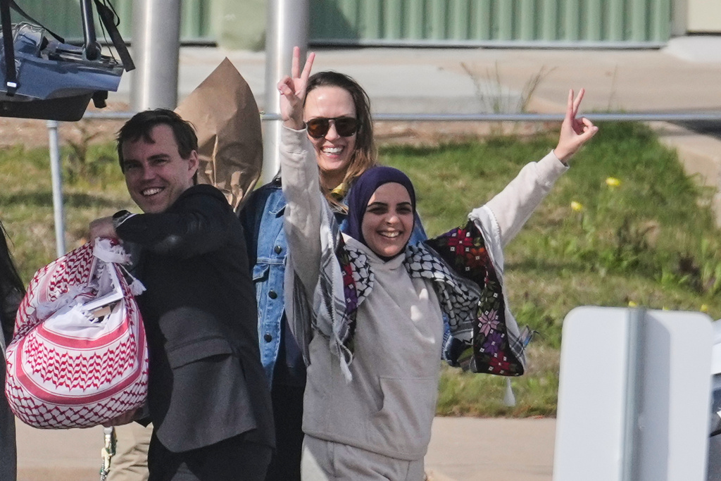 Leqaa Kordia, with hands raised, stands by members of her legal team as she waves to supporters after being released from the Prairieland Detention Center in Alvarado, Texas, Monday, March 16, 2026. (AP Photo/Tony Gutierrez)