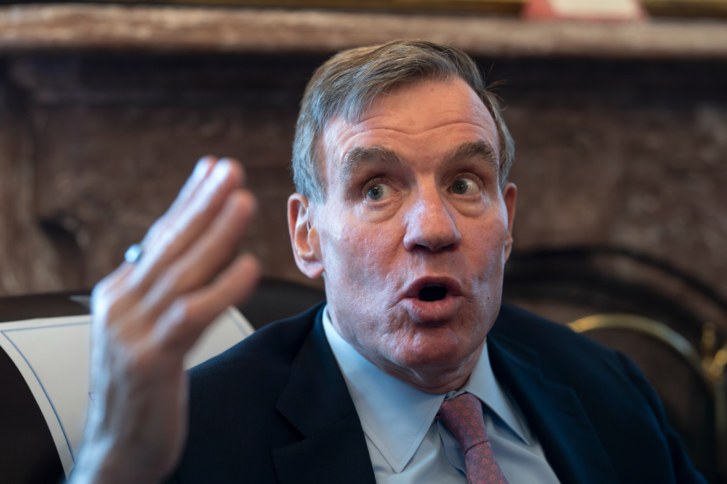 Sen. Mark Warner, D-Va., the vice chair of the Senate Intelligence Committee, speaks to reporters about FISA, the law that allows the U.S. to gather intelligence abroad, at the Capitol in Washington, Thursday, June 11, 2026. (AP Photo/J. Scott Applewhite)