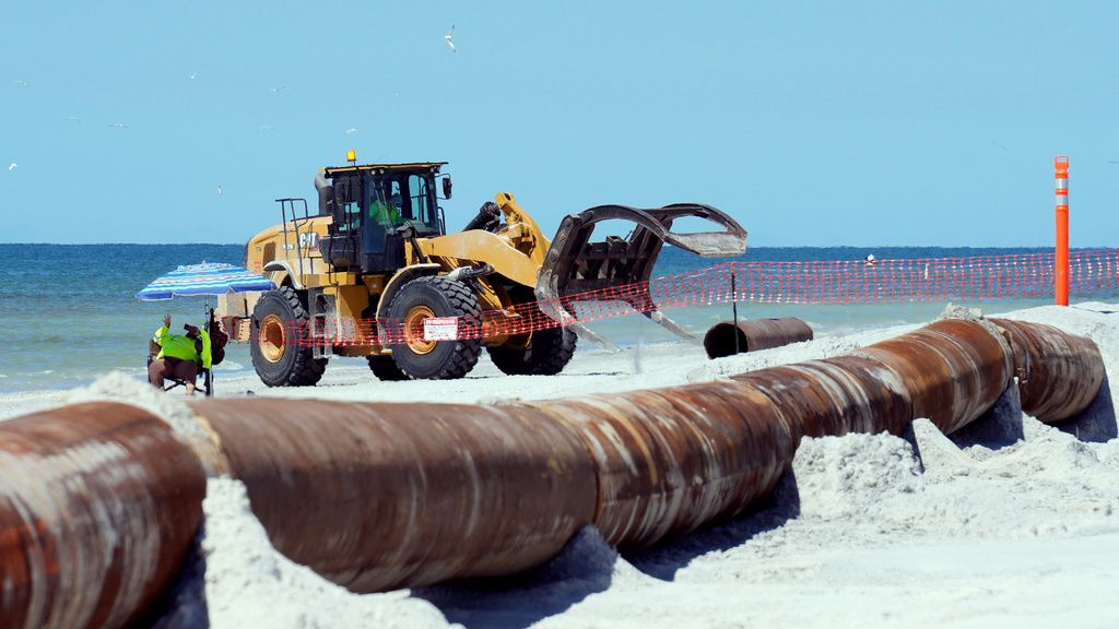 Workers replace the sand washed away by recent hurricanes along the gulf Thursday, Sept. 25, 2025, in Indian Rocks Beach, Fla. (AP Photo/Chris O'Meara)