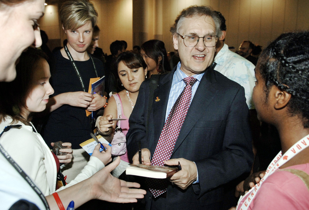 FILE - U.N. Special Envoy for HIV/AIDS in Africa, Stephen Lewis, signs autographs as he leaves the stage following the closing ceremonies of the 16th World Aids Conference, in Toronto, Aug. 18, 2006. (Aaron Harris/The Canadian Press via AP, File)