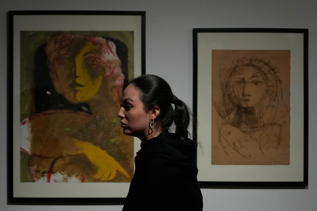A woman visits an exhibition of work by Iranian artist Bahram Dabiri at the Tehran Museum of Contemporary Art in Iran, Thursday, Nov. 20, 2025. (AP Photo/Vahid Salemi)