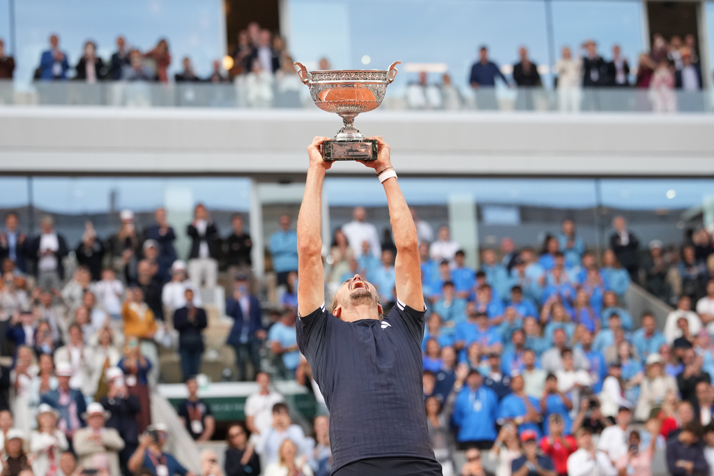 Alexander Zverev of Germany lifts the trophy after winning the men's final match against Flavio Cobolli of Italy at the French Open tennis tournament in Paris, Sunday, June 7, 2026. (AP Photo/Christophe Ena)