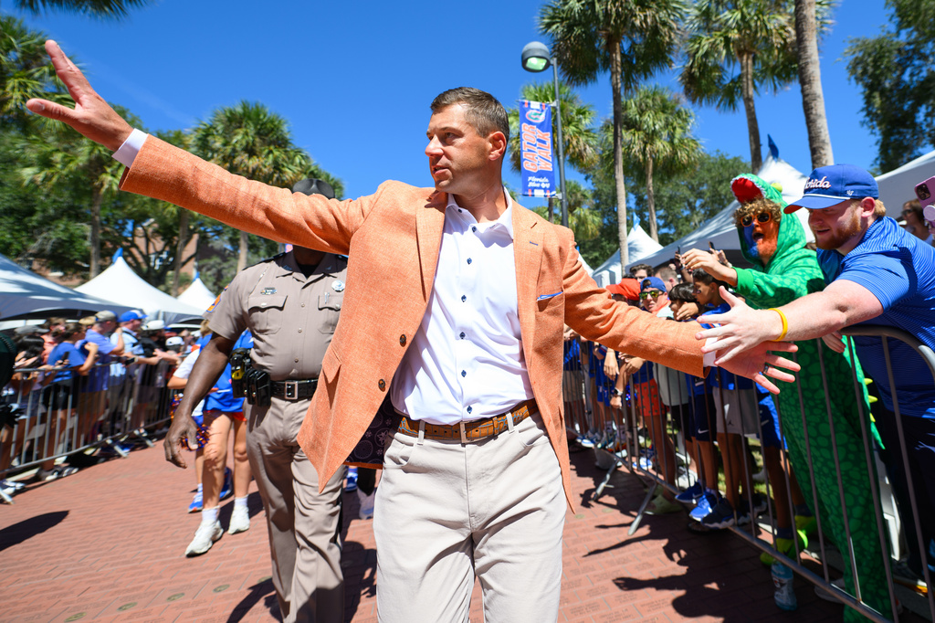 Florida head coach Jon Sumrall greets fans along Gator Walk before an NCAA college football game against Mississippi, Saturday, Sept. 26, 2026, in Gainesville, Fla. (AP Photo/Noah Lantor)