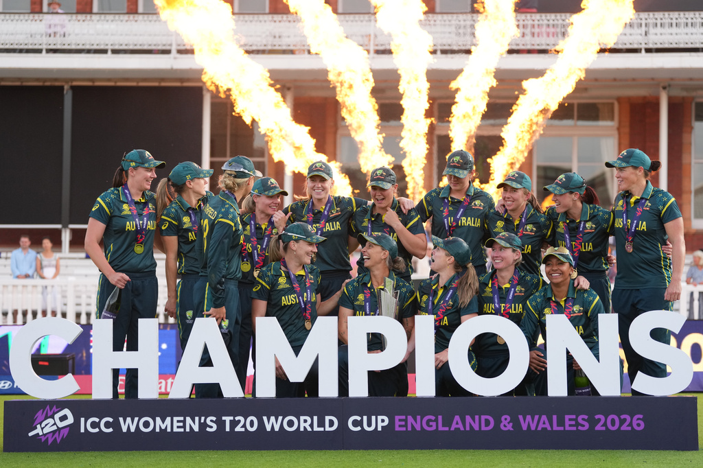 The Australia team celebrate with the trophy after winning the Women's T20 Cricket World Cup final between England and Australia in London, Sunday, July 5, 2026. (AP Photo/Alastair Grant)