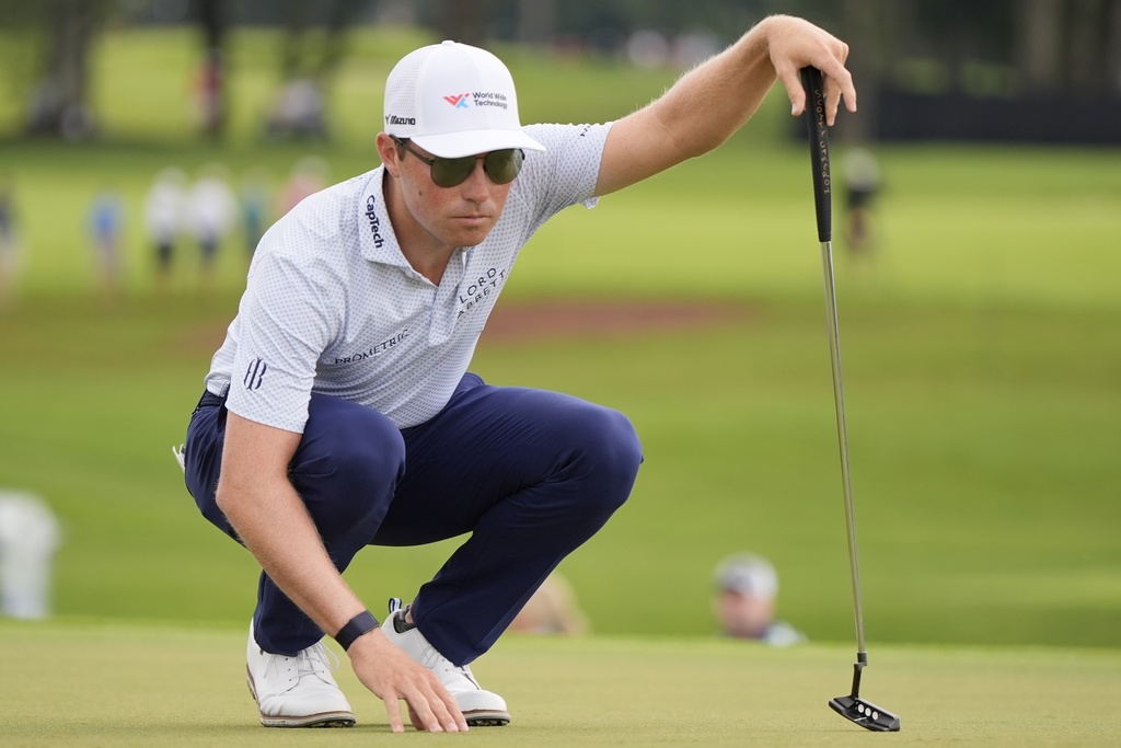 Ben Griffin lines up his putt on the third green during the second round of the Tour Championship golf tournament, Friday, Aug. 22, 2025, in Atlanta. (AP Photo/Mike Stewart)