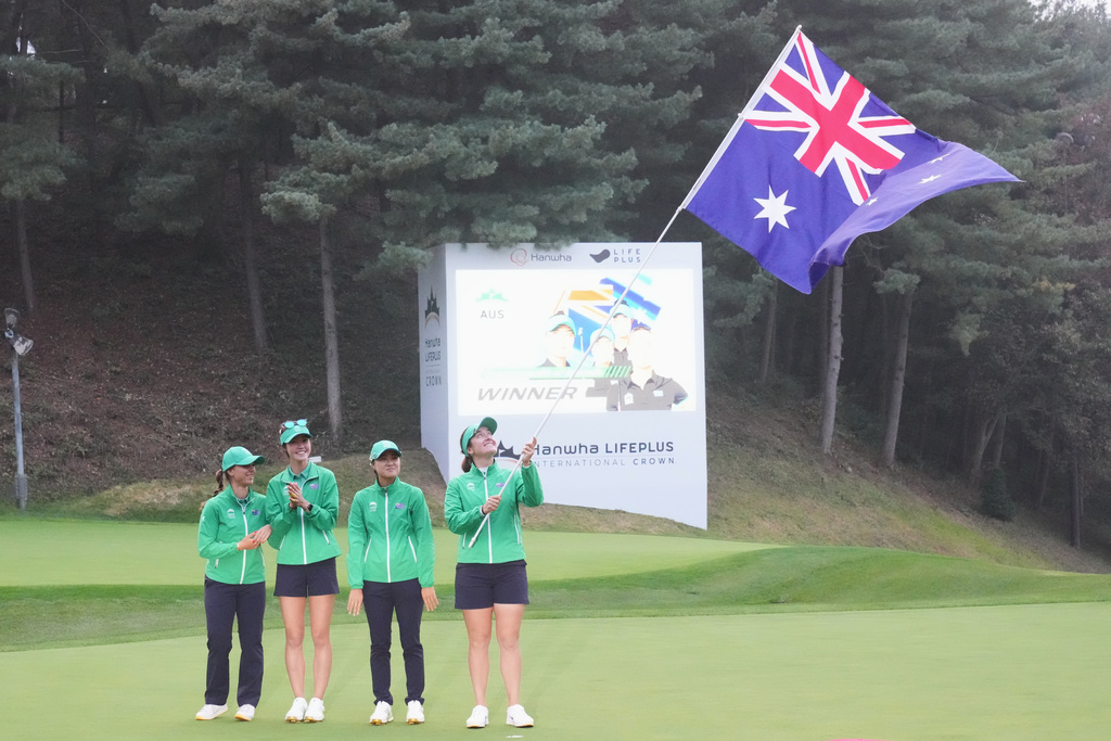 Winners on Australia team from left, Steph Kyriacou, Grace Kim, Minjee Lee, Hannah Green celebrate with Australia flag after winning the LPGA International Crown golf tournament at the New Korea Country Club in Goyang, South Korea, Sunday, Oct. 26, 2025. (AP Photo/Lee Jin-man)