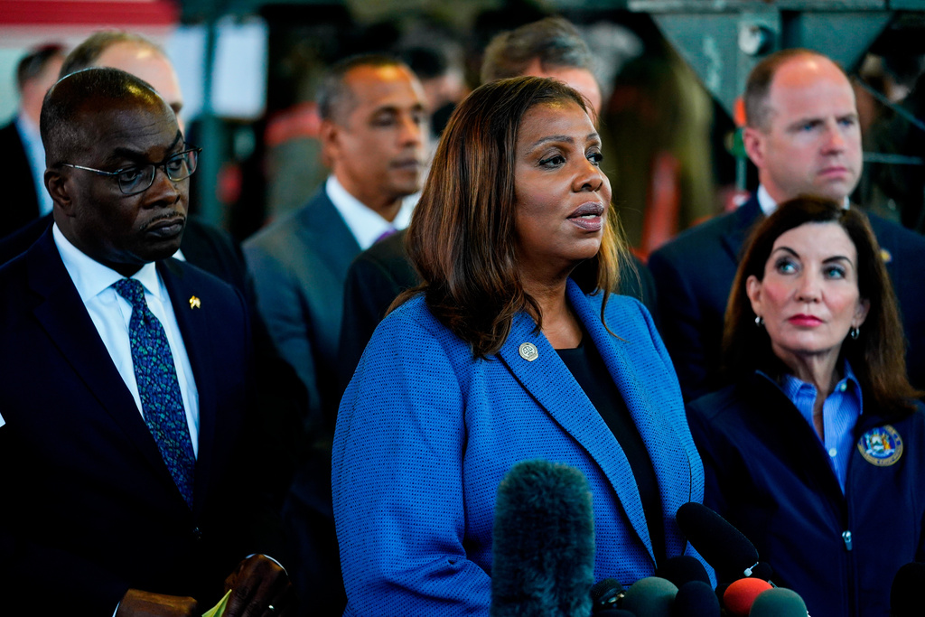 FILE - New York Attorney General Letitia James, center, flanked by Buffalo Mayor Byron Brown, left, and New York Gov. Kathy Hochul, speaks with members of the media during a news conference near the scene of a shooting at a supermarket, in Buffalo, N.Y., May 15, 2022. (AP Photo/Matt Rourke, File)