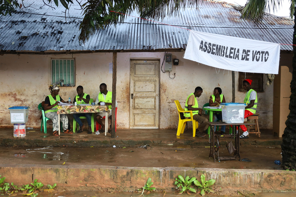 Election officials wait for voters to cast their ballots during a referendum on granting new presidential powers, in Bissau, Guinea Bissau, Sunday, Aug. 30, 2026. (AP Photo/Darcicio Barbosa)