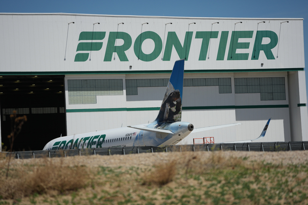 A Frontier Airlines jetliner sits outside a repair hangar at Denver International Airport, Monday, May 11, 2026. (AP Photo/David Zalubowski)