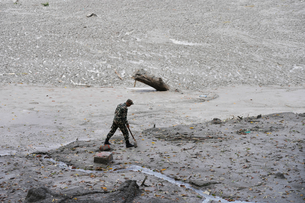 FILE - A policeman searches for bodies along the Trishuli River after flash floods in Nepal's Nuwakot district, Aug. 29, 2026. (AP Photo/Dar Yasin, FIle)