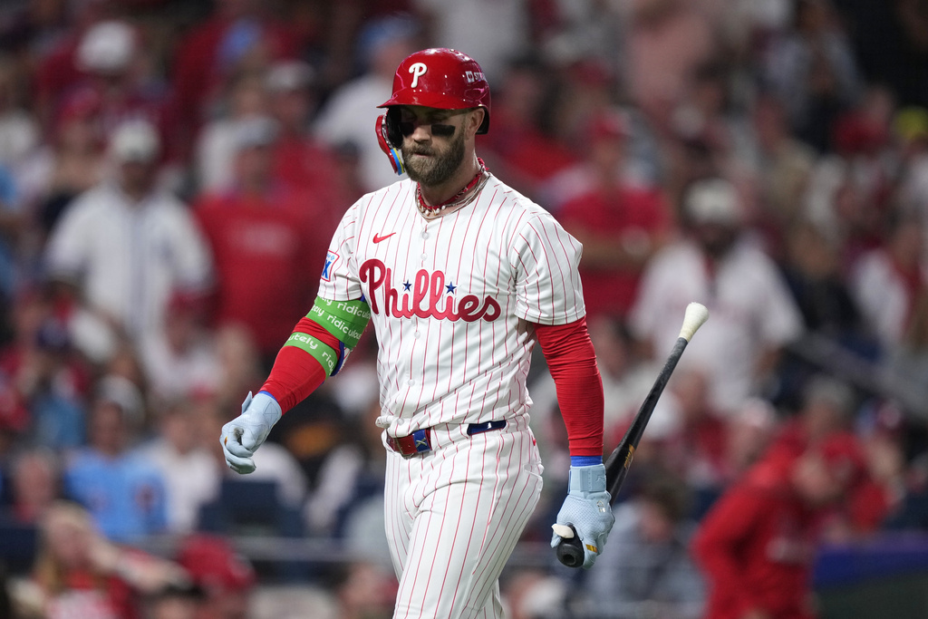 Philadelphia Phillies' Bryce Harper walks back to the dugout after striking out against Los Angeles Dodgers pitcher Shohei Ohtani during the sixth inning in Game 1 of baseball's National League Division Series, Saturday, Oct. 4, 2025, in Philadelphia. (AP Photo/Matt Slocum)