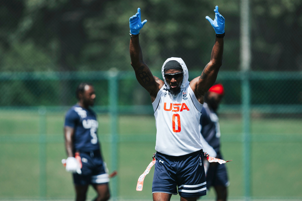 In this image provided by USA Football, Tyler Davis reacts during flag football practice for the United States national team in Charlotte, N.C. (Lester Barnes/USA Football via AP)