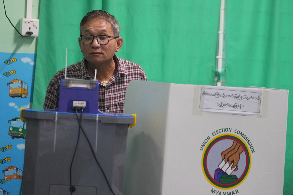 A voter casts ballot at a polling station during the second phase of general election Sunday, Jan. 11, 2026, in Yangon, Myanmar. (AP Photo/Thein Zaw)