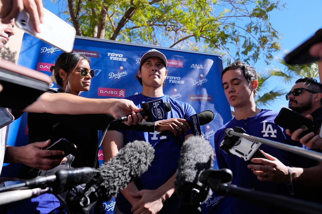 Los Angeles Dodgers two-way player Shohei Ohtani (17) speaks to the media during spring training baseball on Sunday, Feb. 22, 2026, in Phoenix. (AP Photo/Brynn Anderson)