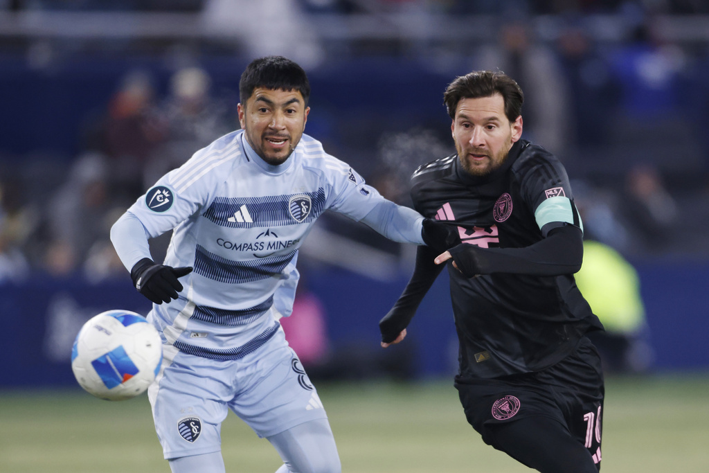 Sporting Kansas City midfielder Memo Rodr&iacute;guez, left, and Inter Miami forward Lionel Messi compete for the ball during the first half of a CONCACAF Champions Cup soccer match, Wednesday, Feb. 19, 2025, in Kansas City, Kan. (AP Photo/Colin E. Braley)