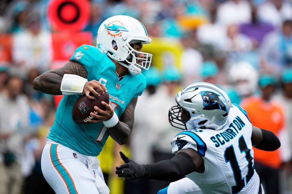 Miami Dolphins quarterback Tua Tagovailoa is sacked by Carolina Panthers linebacker Nic Scourton during the first half of an NFL football game, Sunday, Oct. 5, 2025, in Charlotte, N.C. (AP Photo/Jacob Kupferman)
