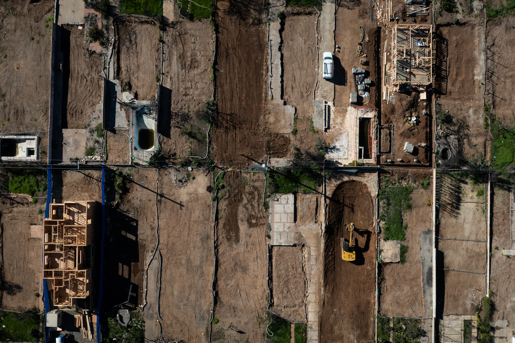 FILE - An aerial view shows houses being rebuilt on cleared lots months after the Palisades Fire, Dec. 5, 2025, in the Pacific Palisades neighborhood of Los Angeles. (AP Photo/Jae C. Hong, File)