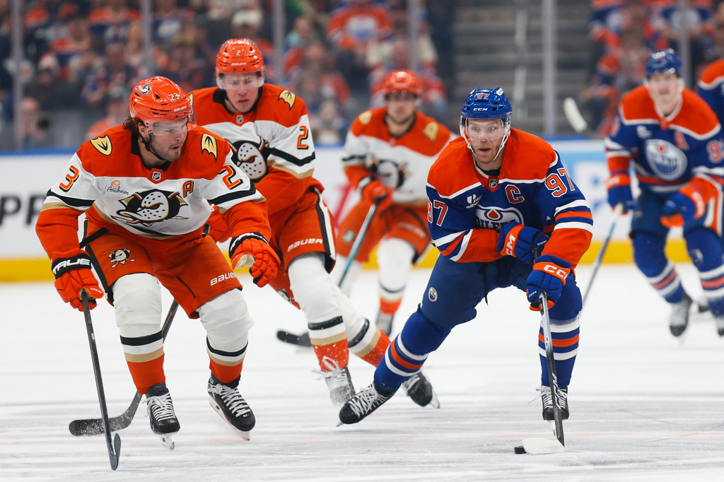 Anaheim Ducks' Mason McTavish (23) defends against Edmonton Oilers' Connor McDavid (97) during the second period of an NHL playoff game in Edmonton on Monday, April 20, 2026. (Codie McLachlan/The Canadian Press via AP)