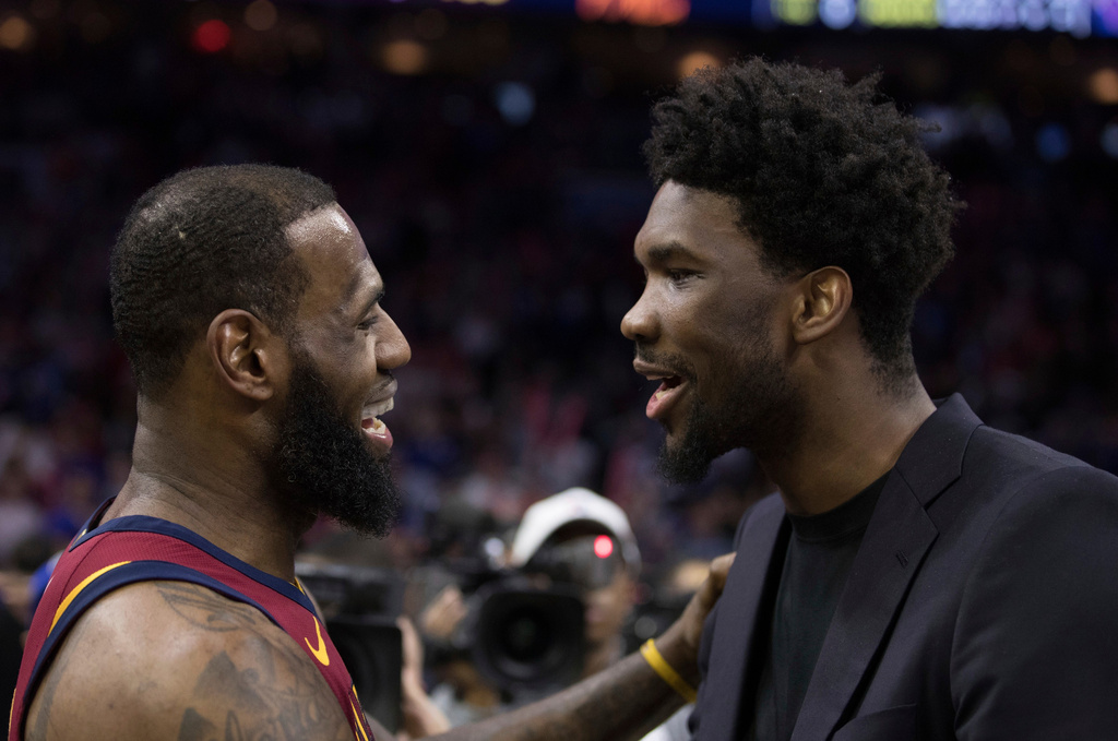 FILE - Cleveland Cavaliers' LeBron James, left, talks with Philadelphia 76ers' Joel Embiid, right, of Cameroon, after the second half of an NBA basketball game, April 6, 2018, in Philadelphia. (AP Photo/Chris Szagola, File)
