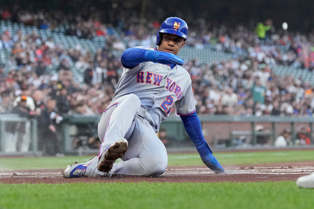 New York Mets' Juan Soto slides into home plate to score on a double by Bo Bichette during the first inning of a baseball game against the San Francisco Giants in San Francisco, Thursday, April 2, 2026. (AP Photo/Tony Avelar)