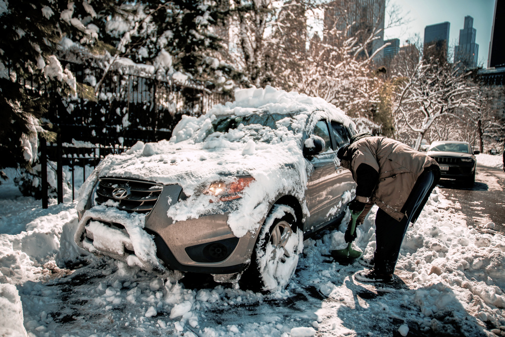 A man shovels snow to take out his car parked in Central Park a day after a winter storm on Tuesday, Feb. 24, 2026, in New York. (AP Photo/Eduardo Munoz Alvarez)