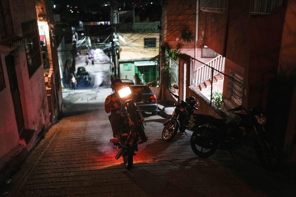 Enderson Betancur rides home in the Las Minas de Baruta neighborhood of Caracas, Venezuela, June 22, 2025. He traveled by land from Caracas to the U.S. border, crossing the Darien Gap, but was deported to Mexico by U.S. authorities and eventually gave up his hopes of reaching the United States, returning home. (AP Photo/Matias Delacroix)