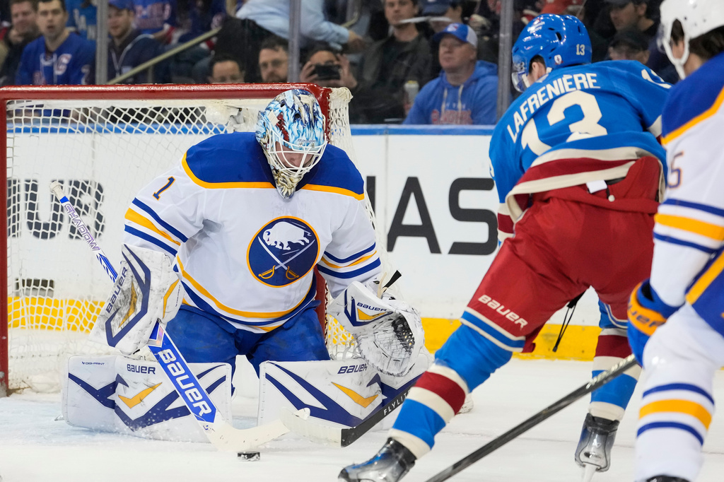 Buffalo Sabres goaltender Ukko-Pekka Luukkonen (1) protect the net from New York Rangers left wing Alexis Lafrenière (13) during the first period of an NHL hockey game, Wednesday, April 8, 2026, in New York. (AP Photo/Yuki Iwamura)