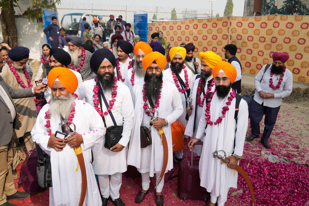 Indian Sikh pilgrims enter Pakistan through the Wagah border crossing point, to participate in celebrations marking the birth anniversary of Guru Nanak, at Gurdwara Janam Asthan Nankana Sahib, near Lahore, Pakistan, Tuesday, Nov. 4, 2025. (AP Photo/K.M. Chaudary)