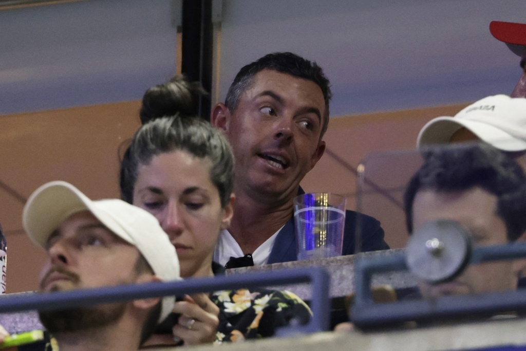 Rory McIlroy, of Northern Ireland, watches a match between Venus Williams, of the United States, and Karolina Muchova, of the Czech Republic, during the first round of the U.S. Open tennis championships, Monday, Aug. 25, 2025, in New York. (AP Photo/Adam Hunger)
