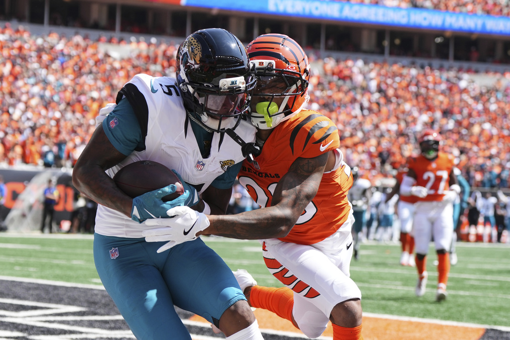 Jacksonville Jaguars wide receiver Dyami Brown (5) catches a touchdown past Cincinnati Bengals cornerback DJ Turner II during the first half of an NFL football game, Sunday, Sept. 14, 2025, in Cincinnati. (AP Photo/Jeff Dean)