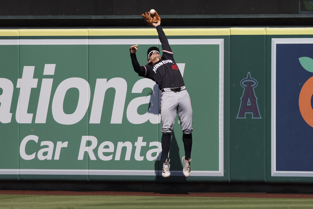 Minnesota Twins center fielder James Outman (43) makes a leaping catch at the wall on ball hit by Los Angeles Angels' Logan Davidson during the fifth inning of a baseball game, Wednesday, Sept. 10, 2025, in Anaheim, Calif. (AP Photo/Jessie Alcheh)