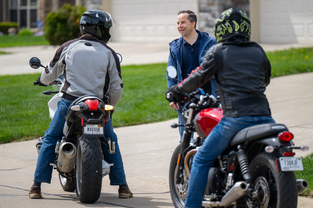 Indiana state Sen. Spencer Deery, R-West Lafayette, who represents District 23, is stopped by passersby while canvassing a neighborhood, Saturday, April 11, 2026, in West Lafayette, Ind. (AP Photo/Doug McSchooler)