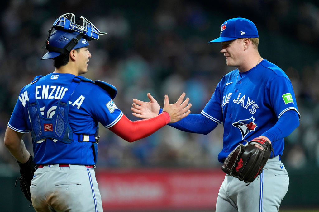 Toronto Blue Jays relief pitcher Braydon Fisher, right, shakes hands with Blue Jays catcher Brandon Valenzuela after the final out in the ninth inning of a baseball game against the Arizona Diamondbacks, Sunday, April 19, 2026, in Phoenix. (AP Photo/Ross D. Franklin)