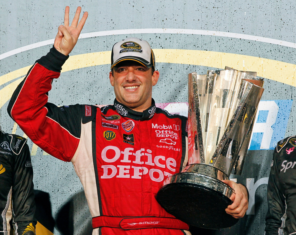 FILE - In this Nov. 20, 2011 file photo, Tony Stewart celebrates after winning his third NASCAR Sprint Cup Series championship, at Homestead-Miami Speedway in Homestead, Fla. (AP Photo/Terry Renna, File)