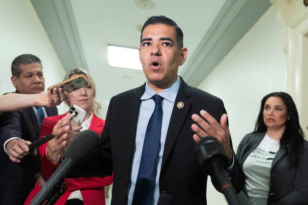 Robert Garcia, D-Calif., House Oversight and Government Reform Committee ranking member, speaks to reporters as Sharlene Rochard, victim of Jeffrey Epstein's abuse, right, listens before the start of a hearing for the deposition of former Attorney General Pam Bondi at the Rayburn House Office Building on Capitol Hill, Friday, May 29, 2026, in Washington. (AP Photo/Manuel Ceneta)