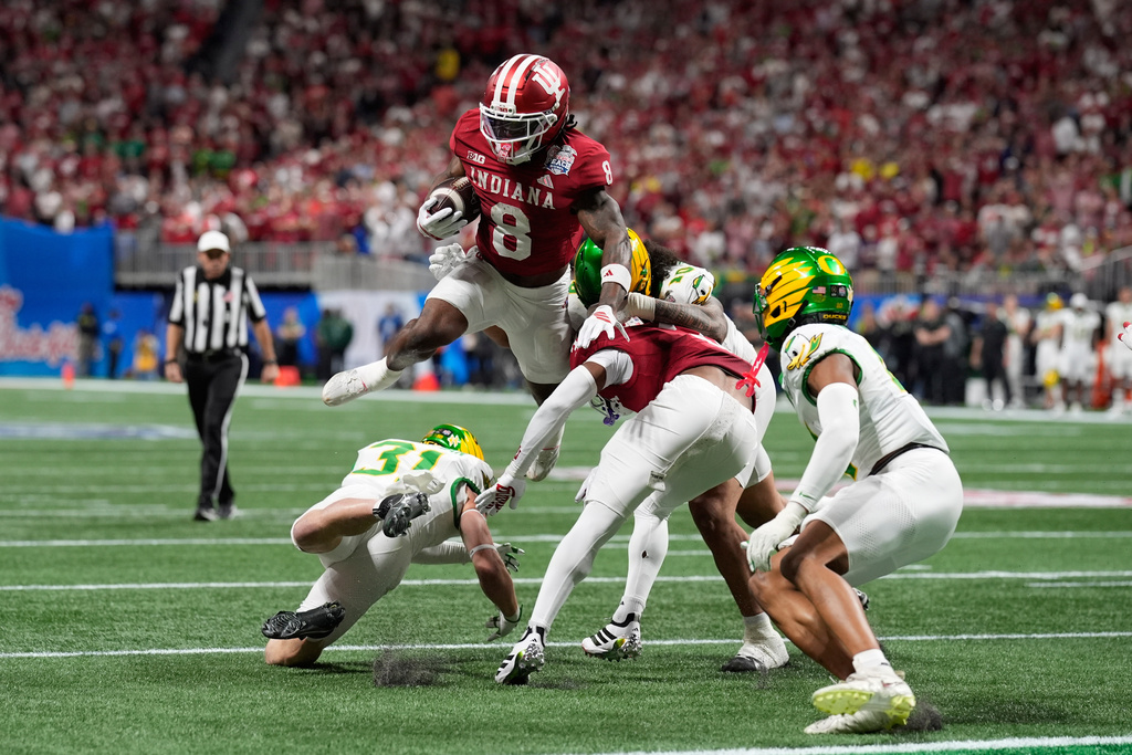 Indiana running back Kaelon Black (8) carries against Oregon during the first half of the Peach Bowl NCAA college football playoff semifinal, Friday, Jan. 9, 2026, in Atlanta. (AP Photo/Mike Stewart)