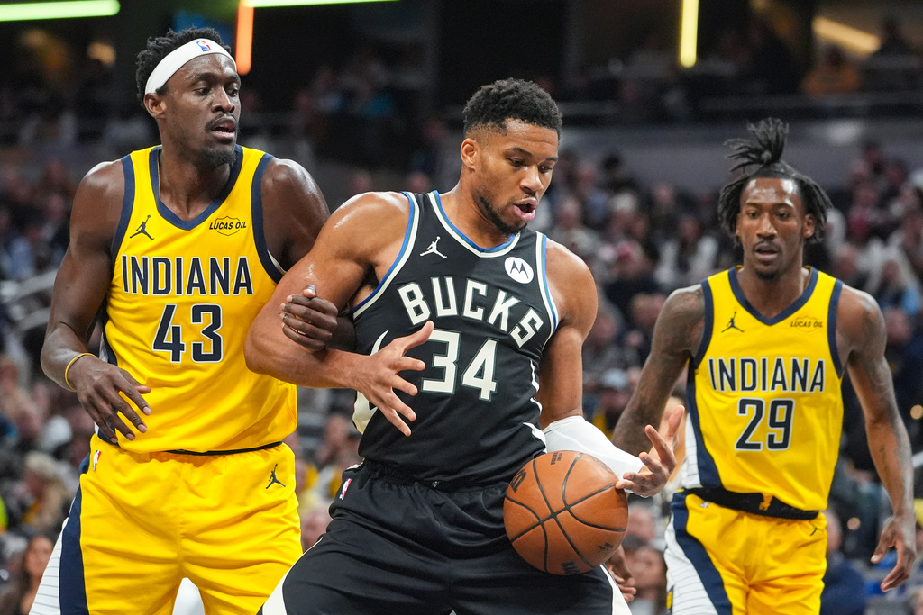 Milwaukee Bucks forward Giannis Antetokounmpo (34) gets tied up with Indiana Pacers forward Pascal Siakam (43) during the first half of an NBA basketball game in Indianapolis, Monday, Nov. 3, 2025. (AP Photo/Michael Conroy)