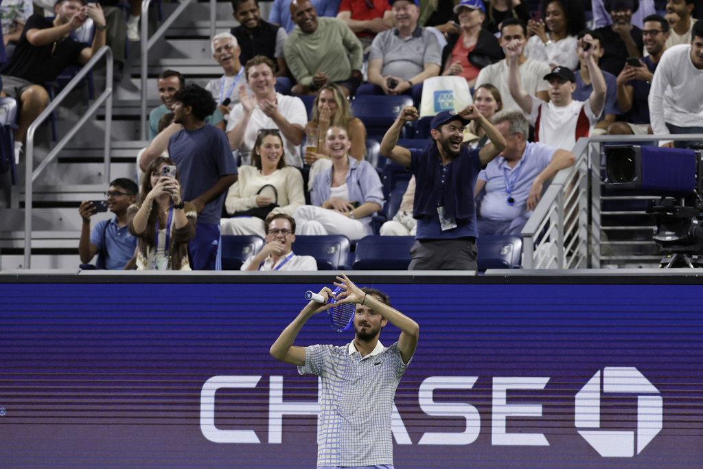 Fans react as Daniil Medvedev, of Russia, gestures after a photographer ran onto the court during a match against Benjamin Bonzi, of France, in the first-round of the U.S. Open tennis championships, Sunday, Aug. 24, 2025, in New York. (AP Photo/Adam Hunger)